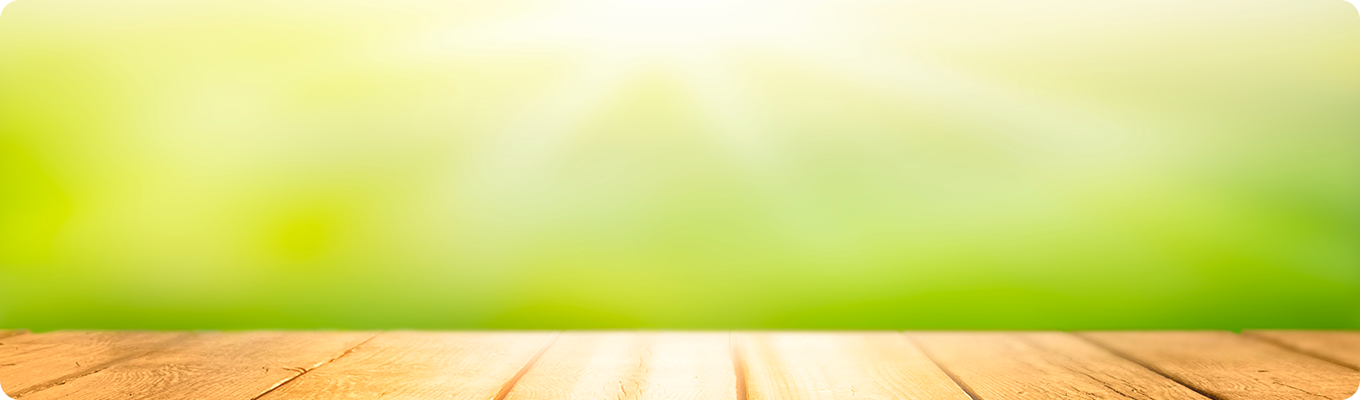 Spring beautiful background with green juicy young foliage and empty wooden table in nature outdoor. Natural template with Beauty bokeh and sunlight.